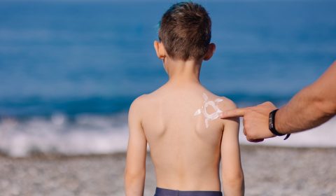 A,Parent,Smears,A,Child,With,Sunscreen.,Sun,Protection.,Preventing