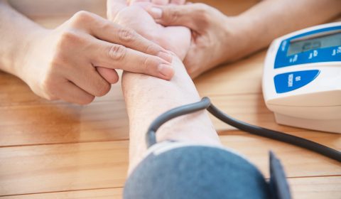 Old lady is being checked blood pressure using blood pressure monitor kid set - people with health care medical instrument set concept